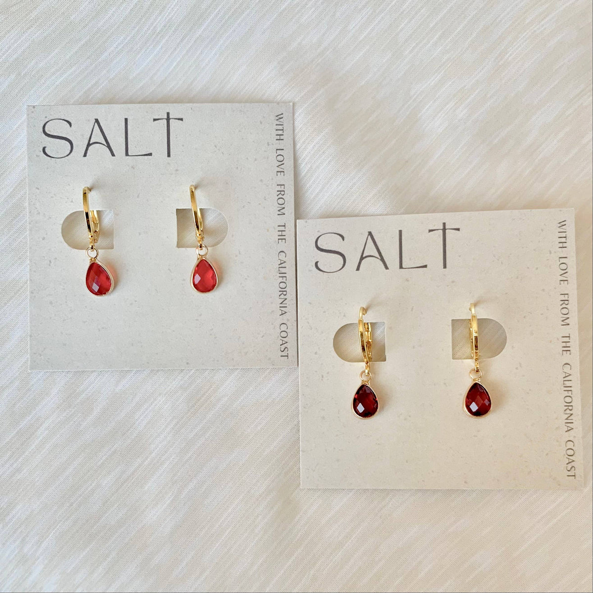 RUBY RED HUGGIE HOOPS | gold
